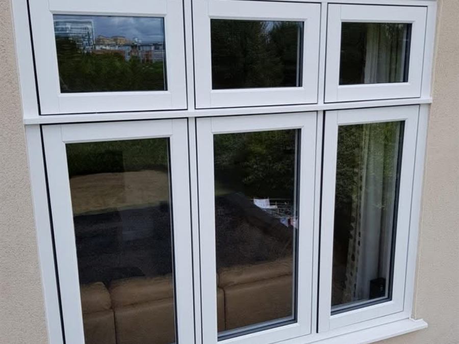 White uPVC flush sash casement window with three top-opening lights, fitted into a rendered wall